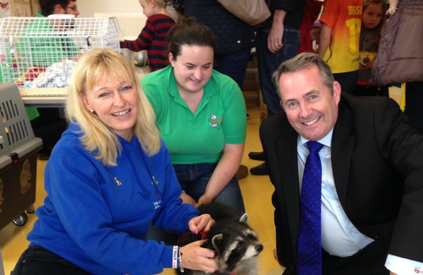 Dr Liam Fox with Sarah Hext and Oreo the racoon