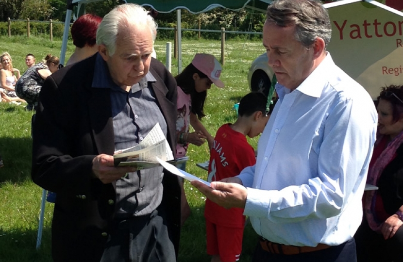 Dr Liam Fox MP talking with a Yatton resident